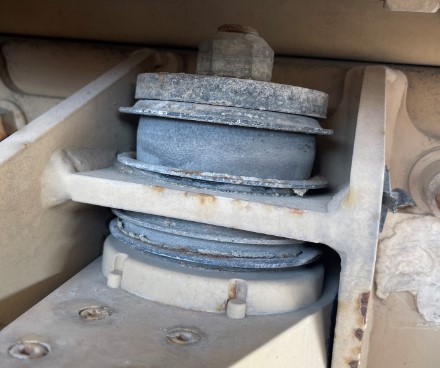 Serviceable shock bushing shown with normal wear.